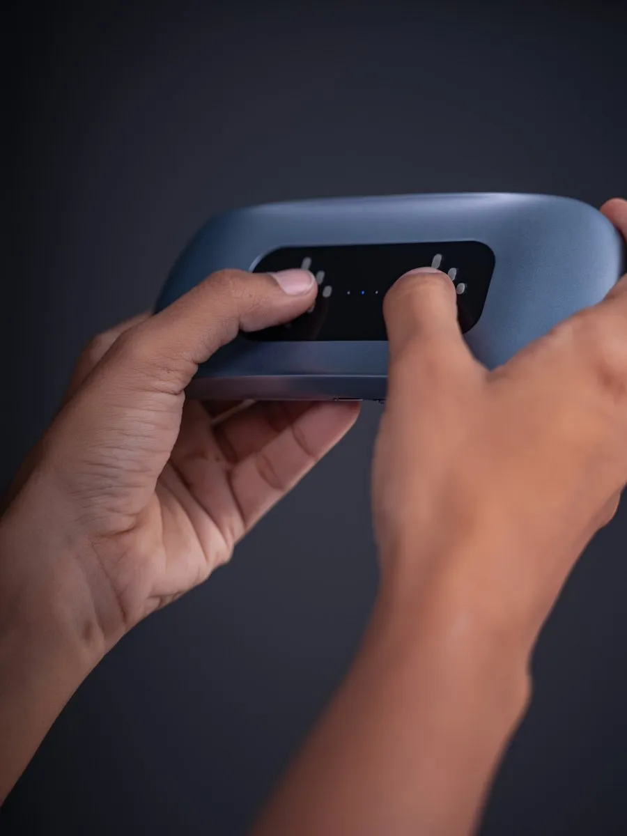 Two thumbs placed on the sensor pad of the EYVA Pro device.